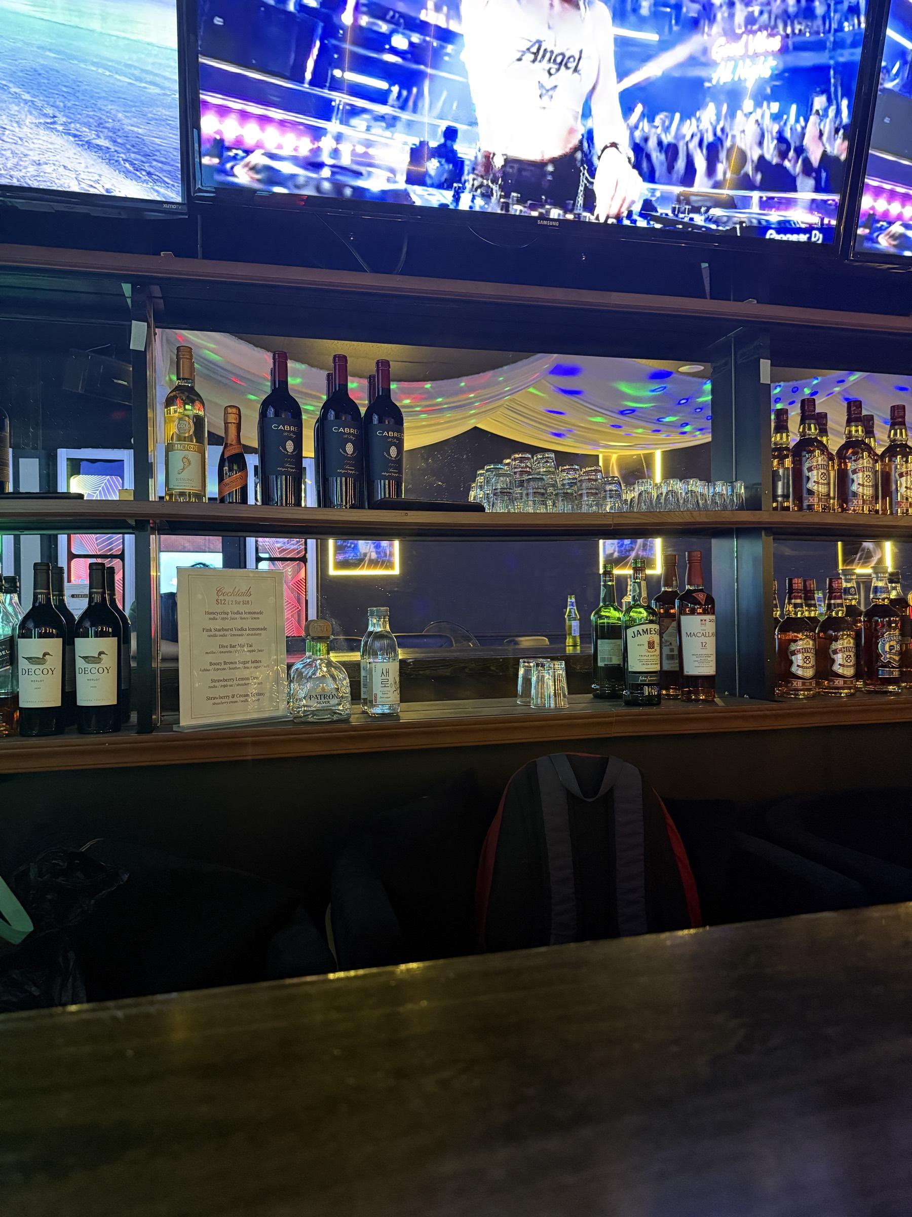 Bottles of Decoy, Cabreo, Jameson and Macallan lined along the back bar shelves.